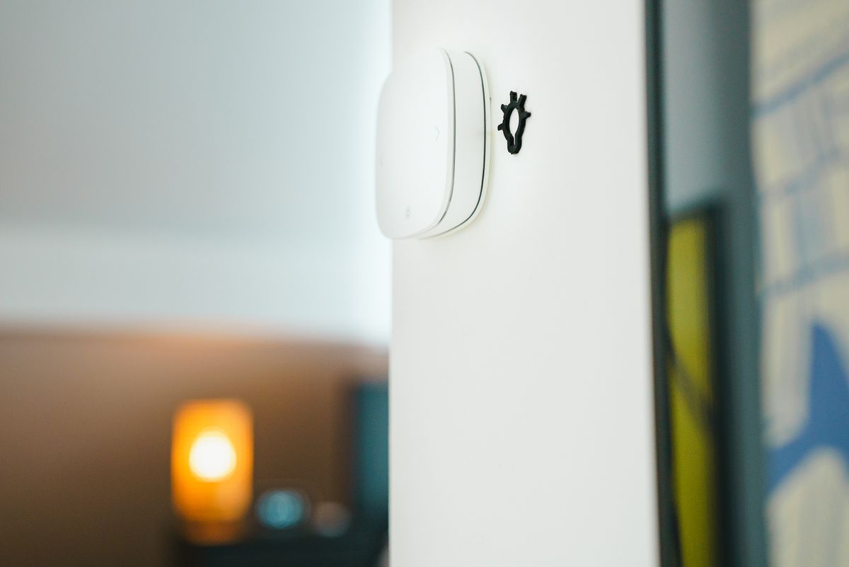 A sleek smart light switch on a wall, controlled wirelessly