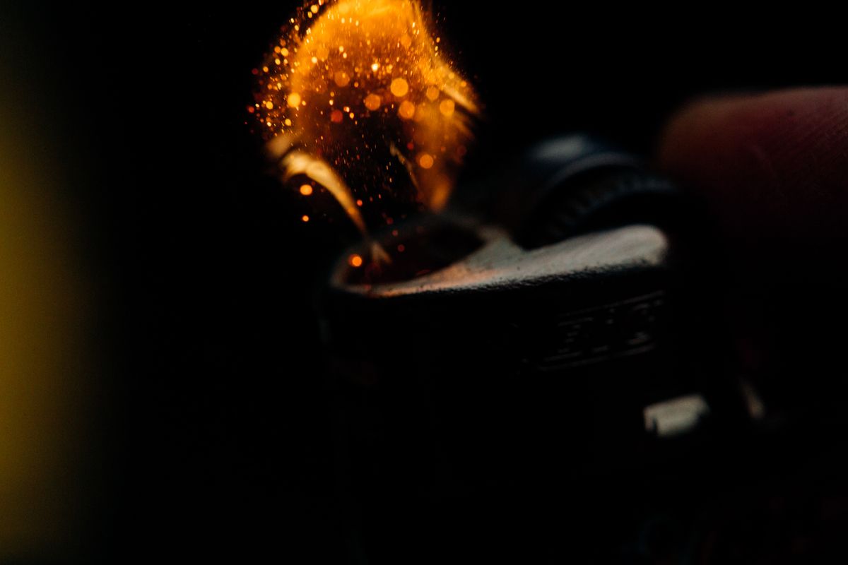 Sparks flying from a lighter, showing how a flint lighter works