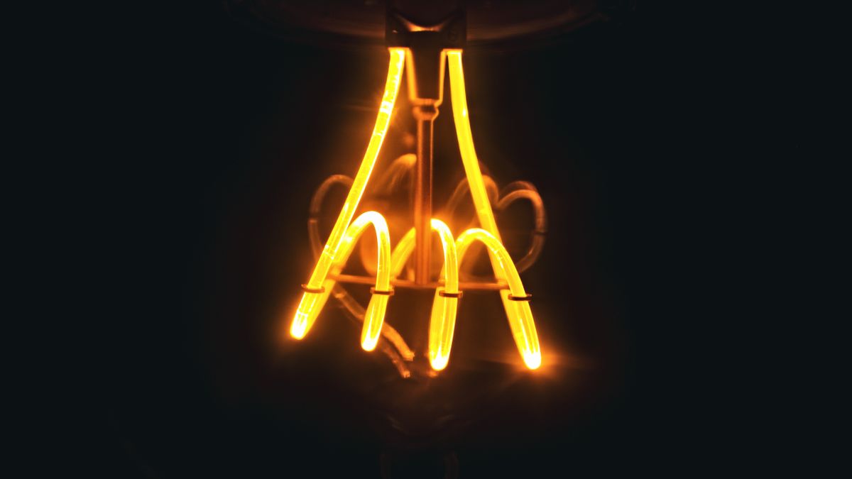 A glowing spiral filament inside an incandescent light bulb